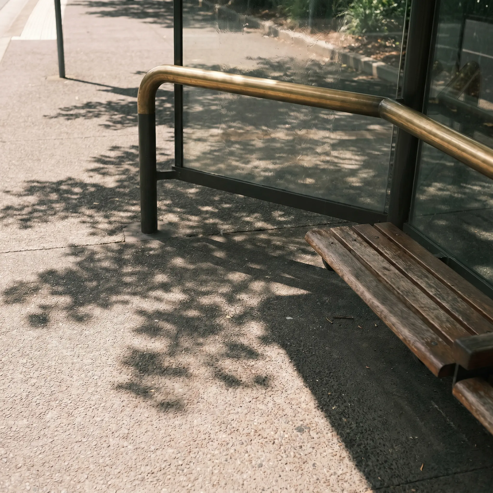 A shaded civic walkway with deep awnings and pale mineral walls